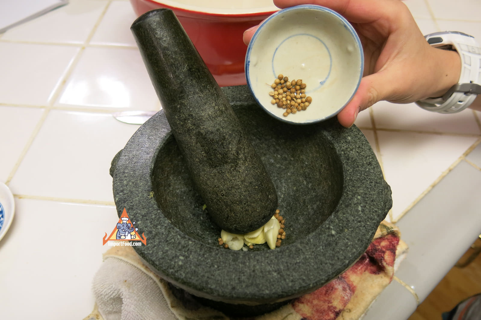 Pound coriander seed and garlic