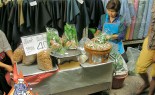 Bangkok Vendor Prepares Miang Kham on a Busy Pathway in the Fabric District